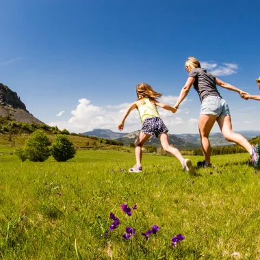 Family running towards Mont-Gerbier-de-Jonc in spring