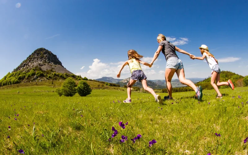 Family running towards Mont-Gerbier-de-Jonc in spring