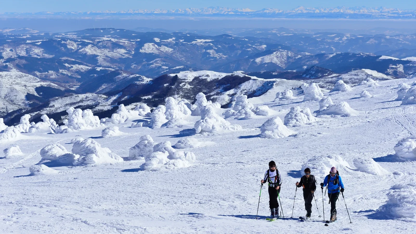 Group of friends cross-country skiing on a snow-covered Mont-Mézenc