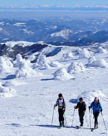 Group of friends cross-country skiing on a snow-covered Mont-Mézenc