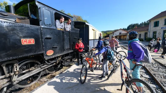 Family waiting to board their bikes on the Train de l'Ardèche in summer
