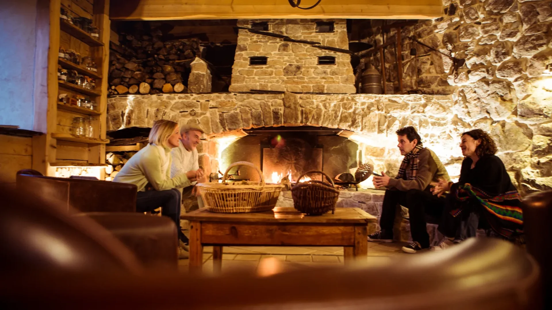 Group of friends by the fireplace, in the guest house of the "Moulin de Montabonnel", in winter