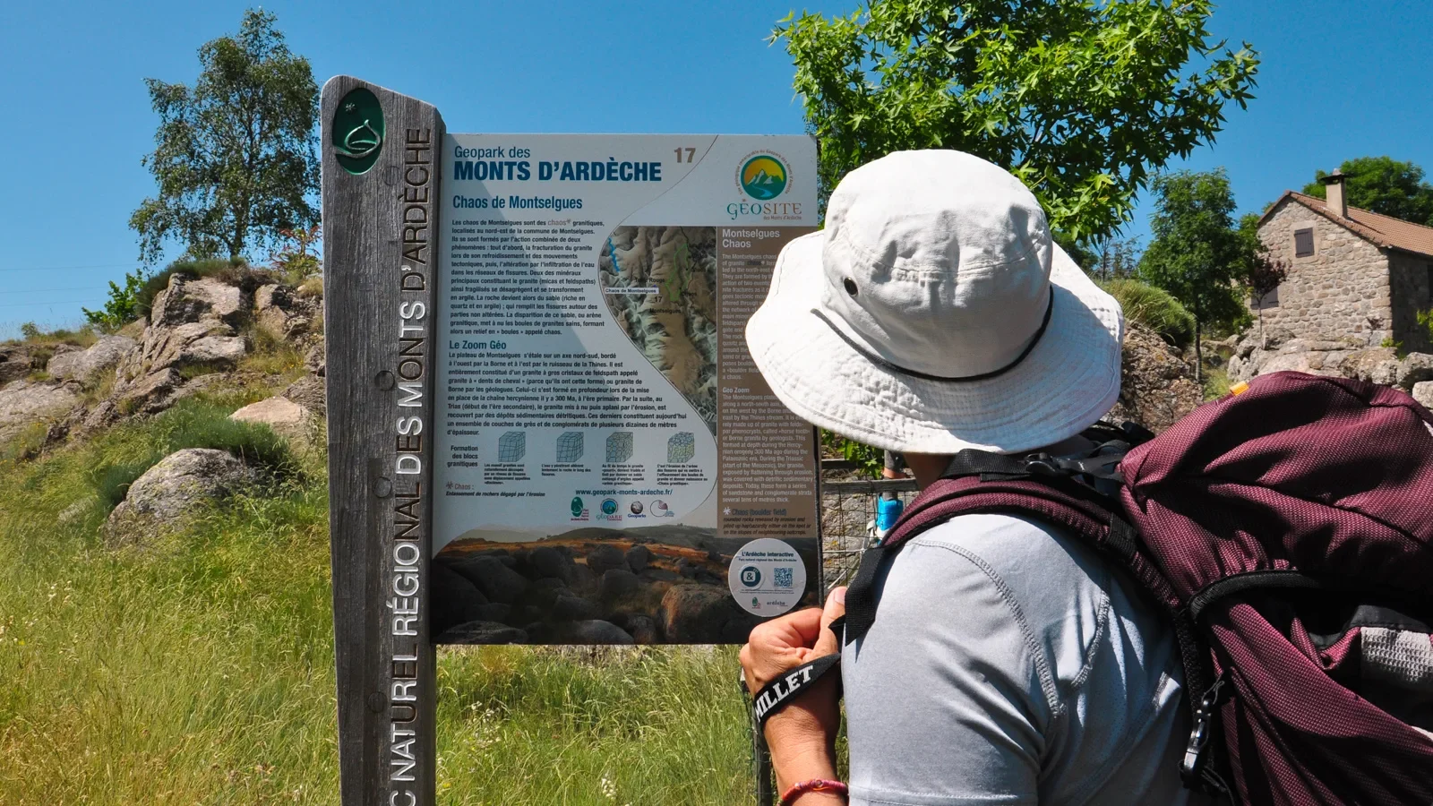 Woman looking at a panel of the Montselgues chaos geosite
