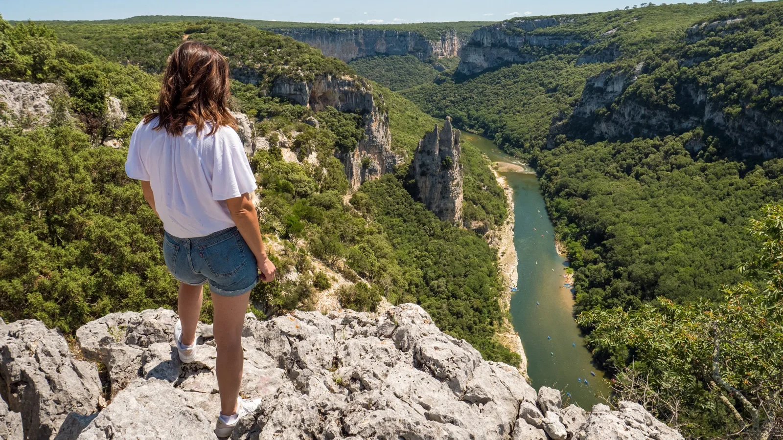 Woman observing the landscape of the Ardèche gorges, in summer, with the "Cathedral Rock"