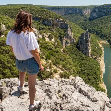 Woman observing the landscape of the Ardèche gorges, in summer, with the 