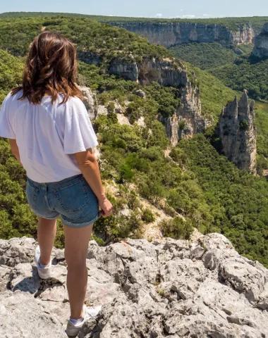Woman observing the landscape of the Ardèche gorges, in summer, with the 