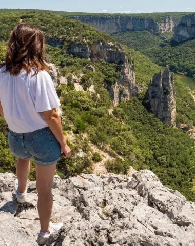 Woman observing the landscape of the Ardèche gorges, in summer, with the 