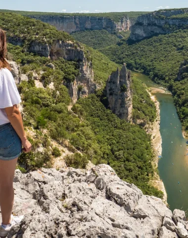 Woman observing the landscape of the Ardèche gorges, in summer, with the 