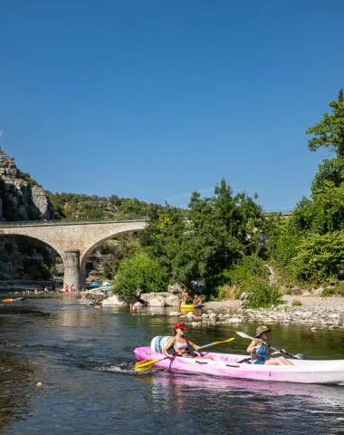 Women in a canoe near the village with outstanding character of Balazuc, in summer