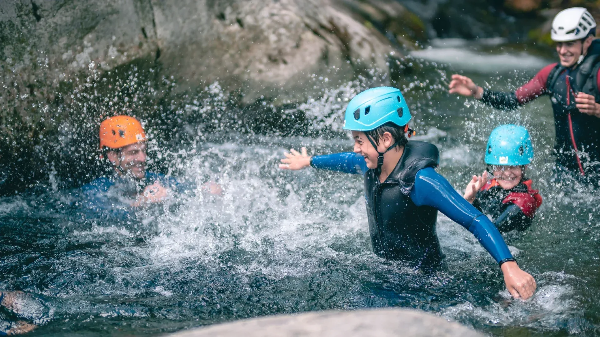 Family practicing canyoning