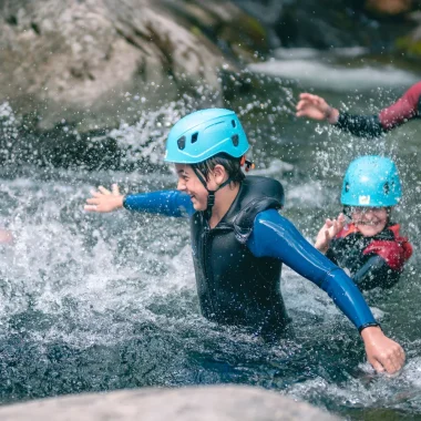 Family practicing canyoning