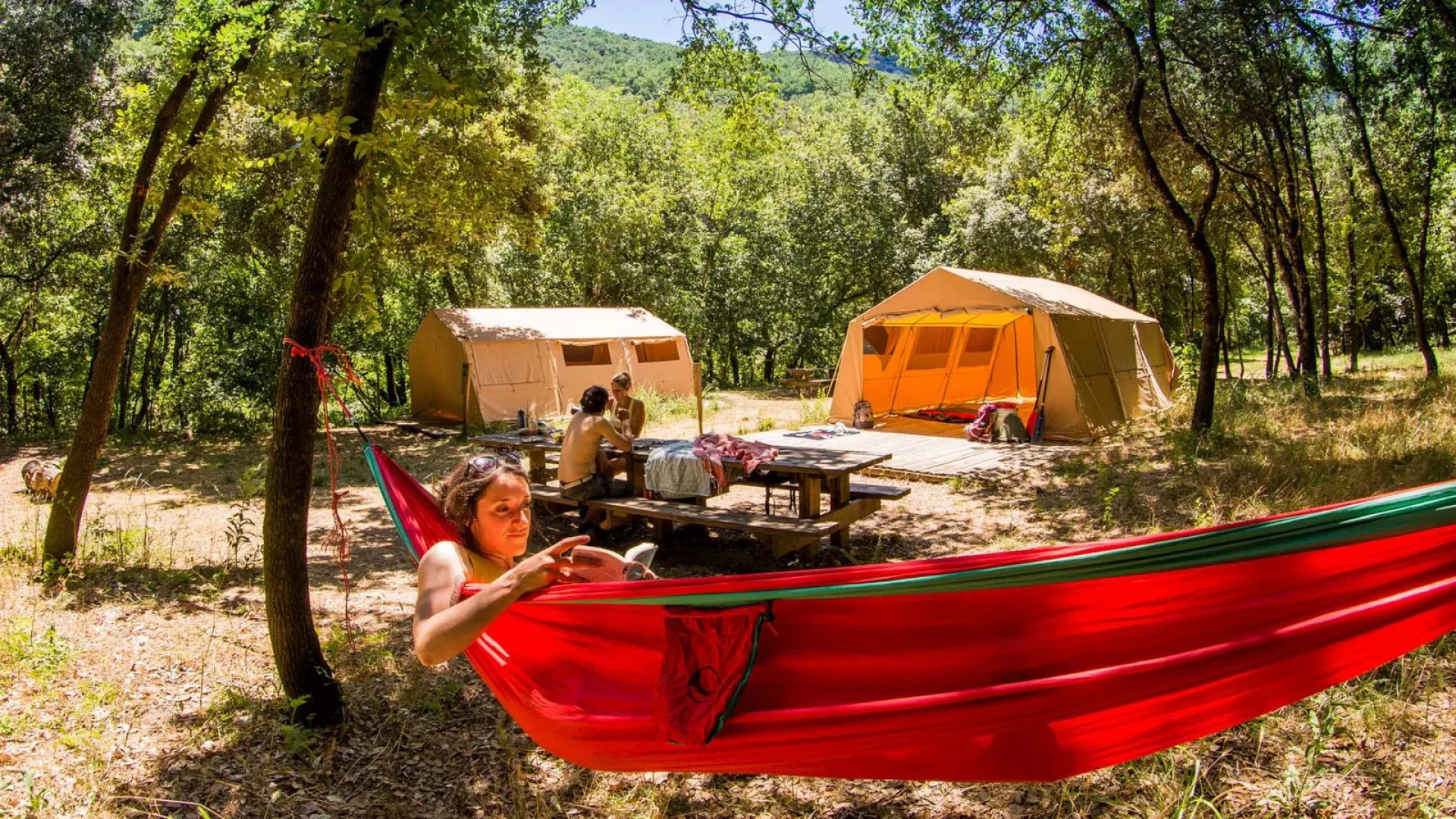 Woman relaxing in a hammock during a bivouac in the Ardèche Gorges, in summer